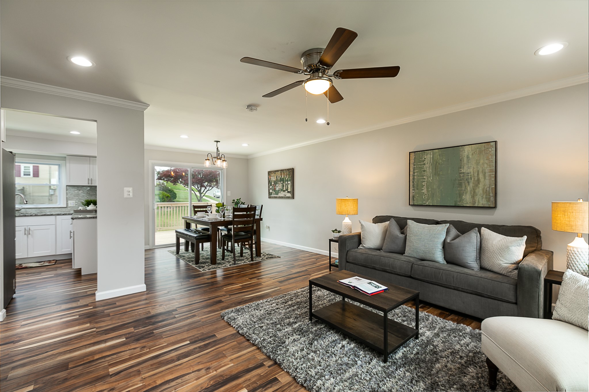 Living room with dark hardwood floors, gray sofa and area rug in Lyons, NY
